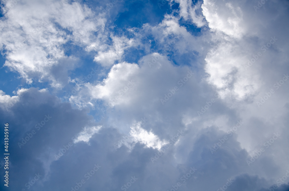 Blue sky with gray cumulus clouds