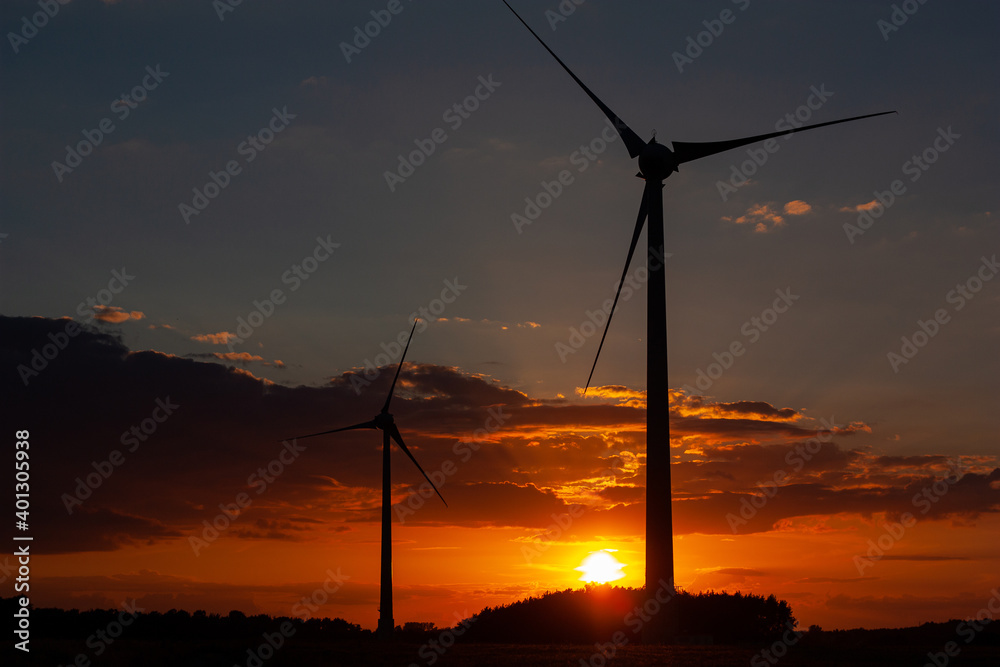 Obraz premium Two windmills in the sunset