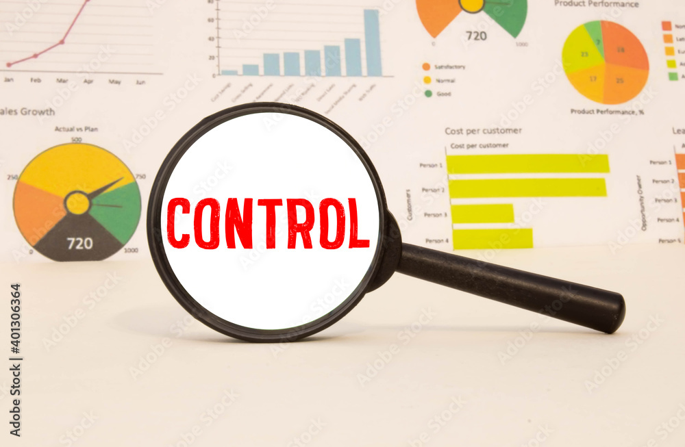On the desktop, graphs, reports, a magnifying glass with the inscription CONTROL. On the desktop, graphs, reports, a magnifying glass with the inscription CONTROL.