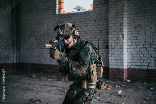 Soldier in full US MARSOC equipment entering abandoned building, aiming different angles with MK18 assault rifle