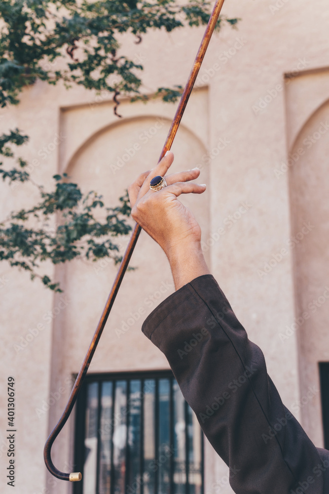 Arabic man spinning stick yowla - obrazy, fototapety, plakaty 