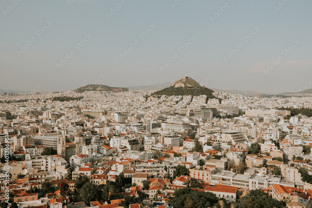Beautiful historic city of Athens during sunny day and mountains in background,Greece.