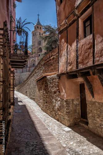 paved street in the medieval city of Albarracin in the province of Teruel  Aragon Spain in a sunny day  the cathedral of Albarracin in the background