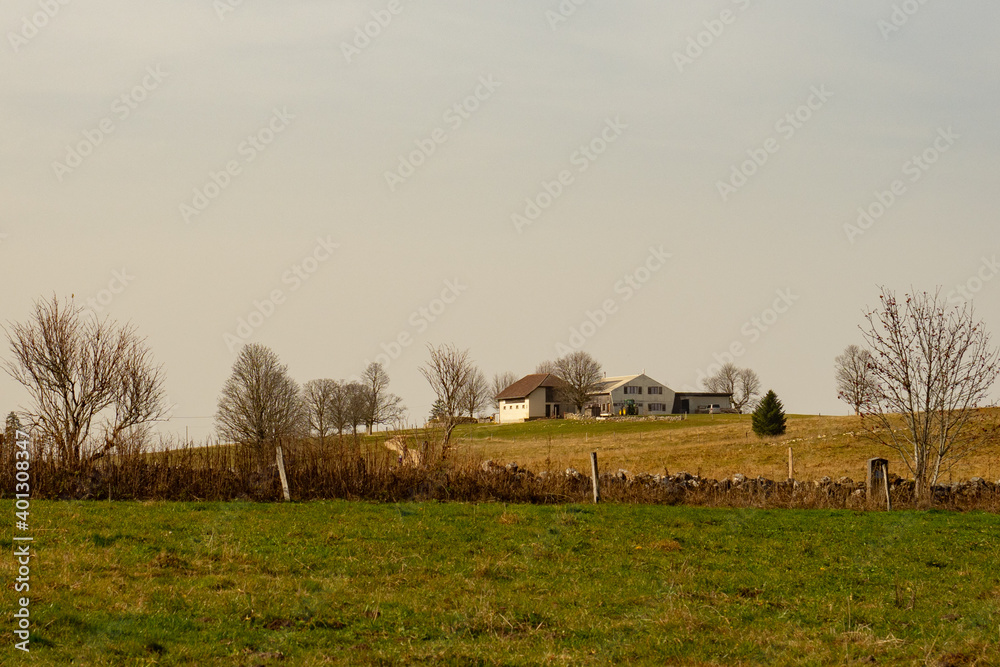 Fototapeta premium A farming house in the Swiss Jura mountains on a beautiful autumn day