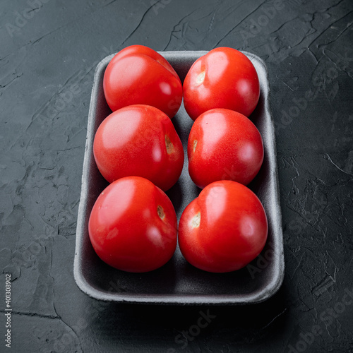 Fresh red organic tomatoe, on black background