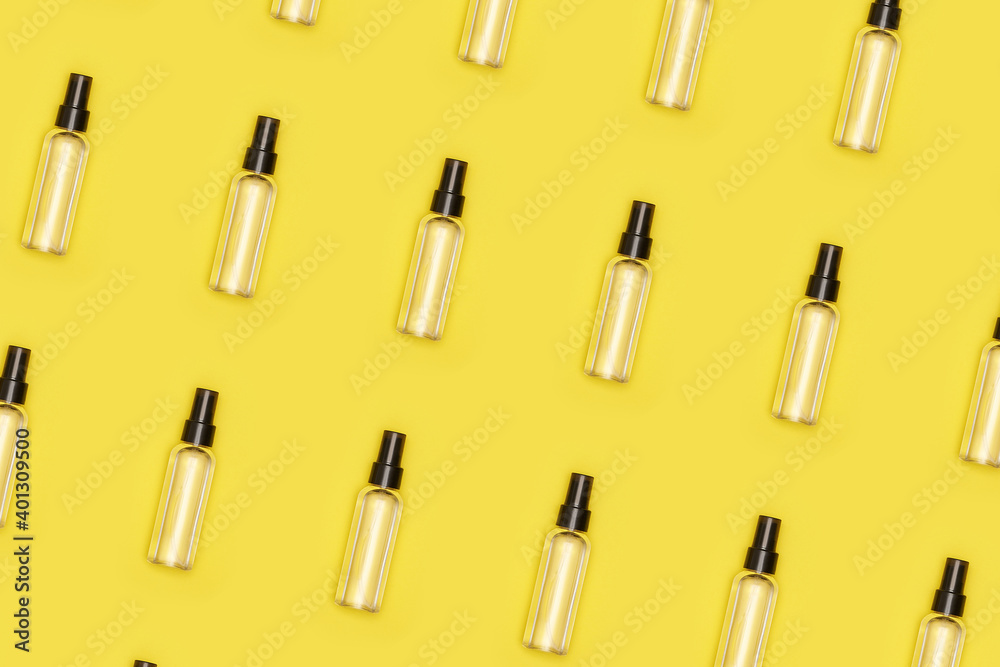 Fototapeta premium transparent cosmetic or antiseptic bottle on yellow isolated background pattern. High quality photo