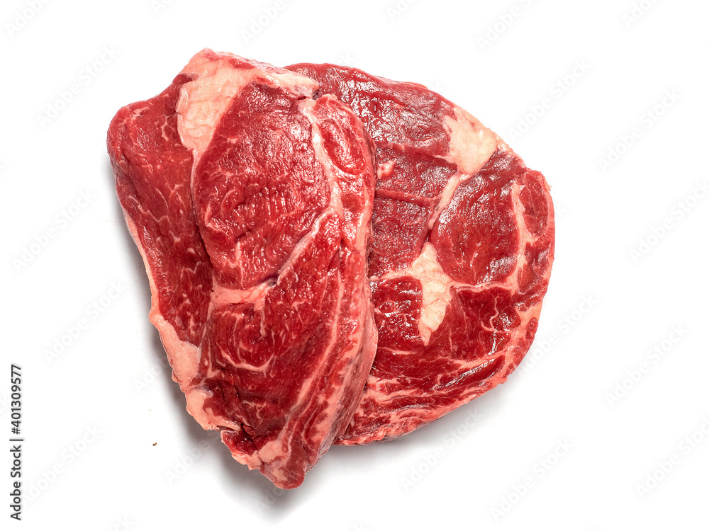 Fresh raw rib eye steak on white isolated surface. Meat industry product. Premium tender meat cut. Top down view