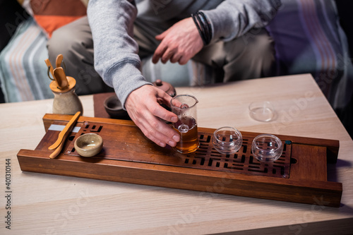 Recipe for creating delicious black tea according to chinese traditions. Close-up set of glass and clay dishes for tea. Flasks and kettle