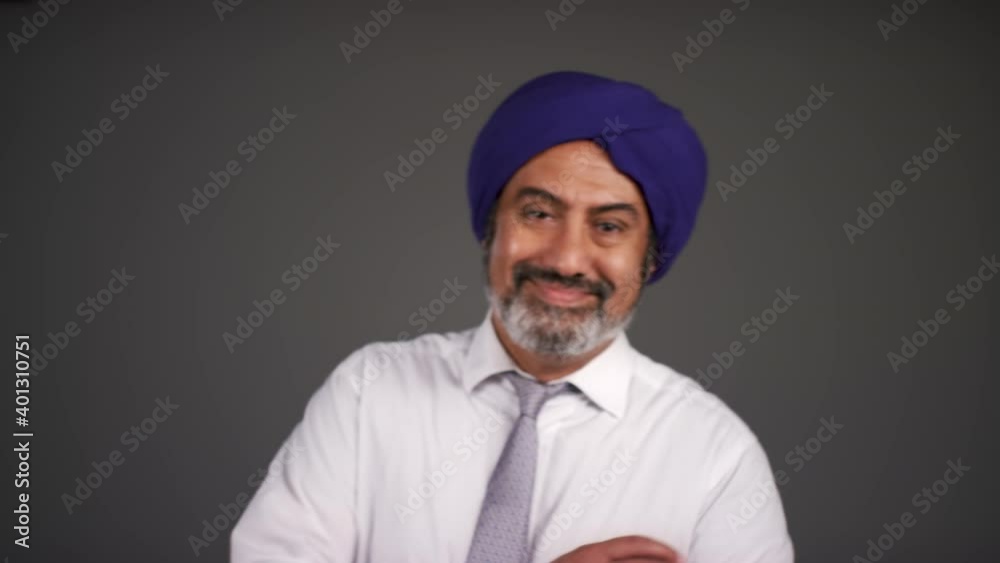 Pull Focus of Smart Middle Aged Man In Turban Smiling Pull Focus of Smart Middle Aged Man In Turban Smiling