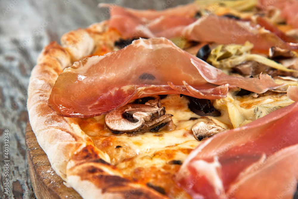 Fototapeta premium Pizza with Serrano ham, mushrooms and sliced black olives