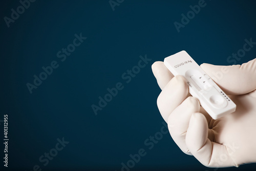 Doctor holding a test kit for viral disease tests with the COVID-19 SARS-CoV-2 laboratory card kit for the novel viral coronavirus sars cov 2 virus (formerly known as 2019-nCov) photo