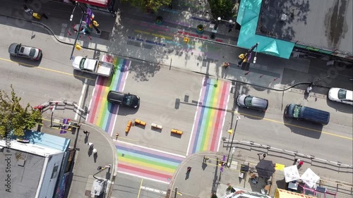 super slow aerial twist over gay pride LGBTQ downtown community with 4 painted road flags describing sexuality of the village davie and bute vancouver canada 1-2 photo