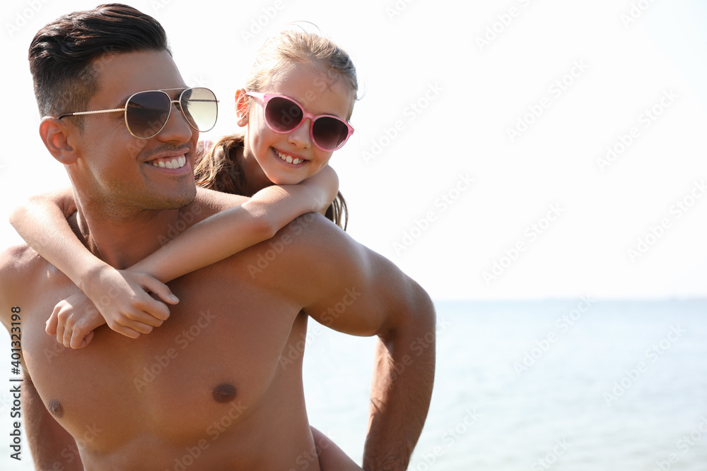 Father playing with daughter at beach. Family vacation Father playing with daughter at beach. Family vacation