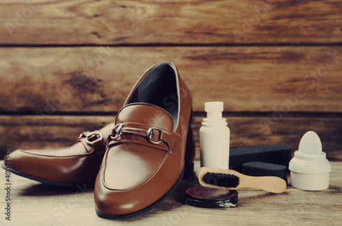Shoe care accessories and footwear on wooden table