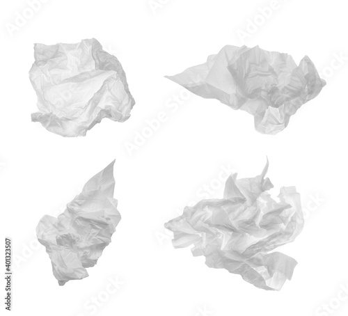 Set with used crumpled paper tissues on white background