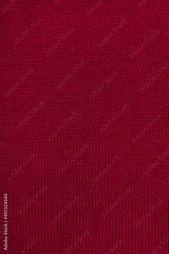Fototapeta premium Red wool knitted canvas, hand knit, plain knitting, clouseup, vertical photo