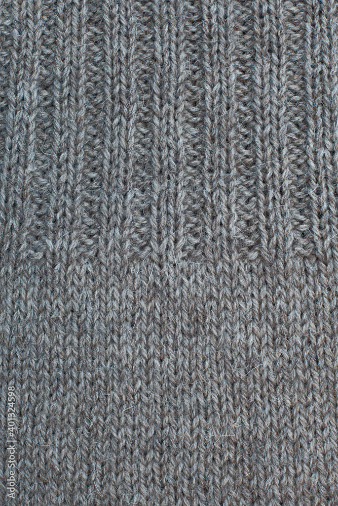 Wool knitted canvas, tricot, hand knit, needle work, ribs, plain knitting, stockinette stitch, natural color, clouseup. Wool knitted canvas, tricot, hand knit, needle work, ribs, plain knitting, stockinette stitch, natural color, clouseup.