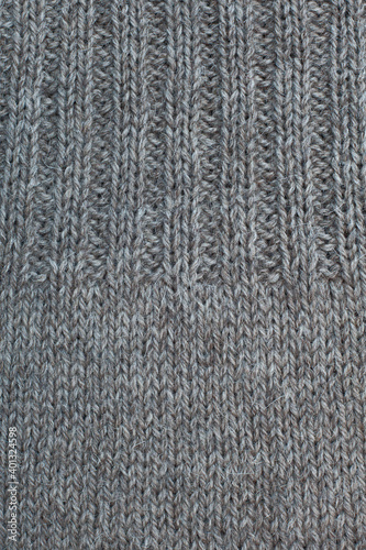 Wool knitted canvas, tricot, hand knit, needle work,  ribs, plain knitting, stockinette stitch,  natural color, clouseup.
