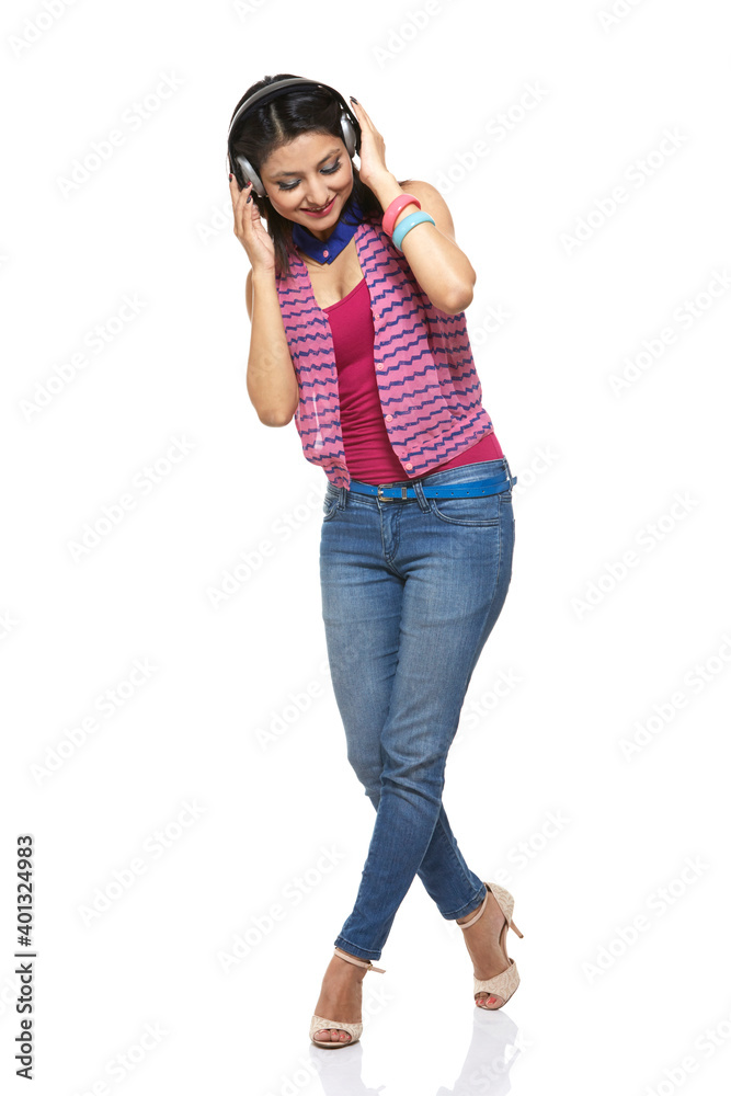 Attractive young women dancing with headphones on white. Attractive young women dancing with headphones on white.