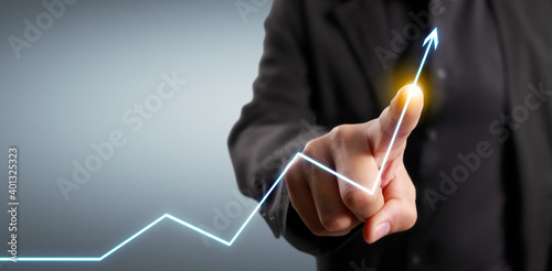 Hand touching graphs of financial indicator and market analysis chart