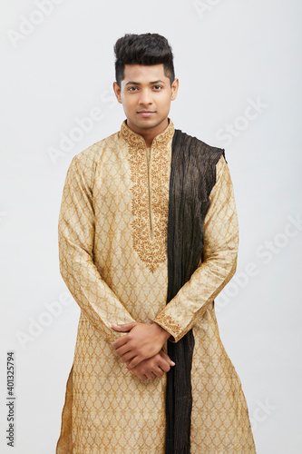 Photography Attractive happy north Indian young groom in traditional dress