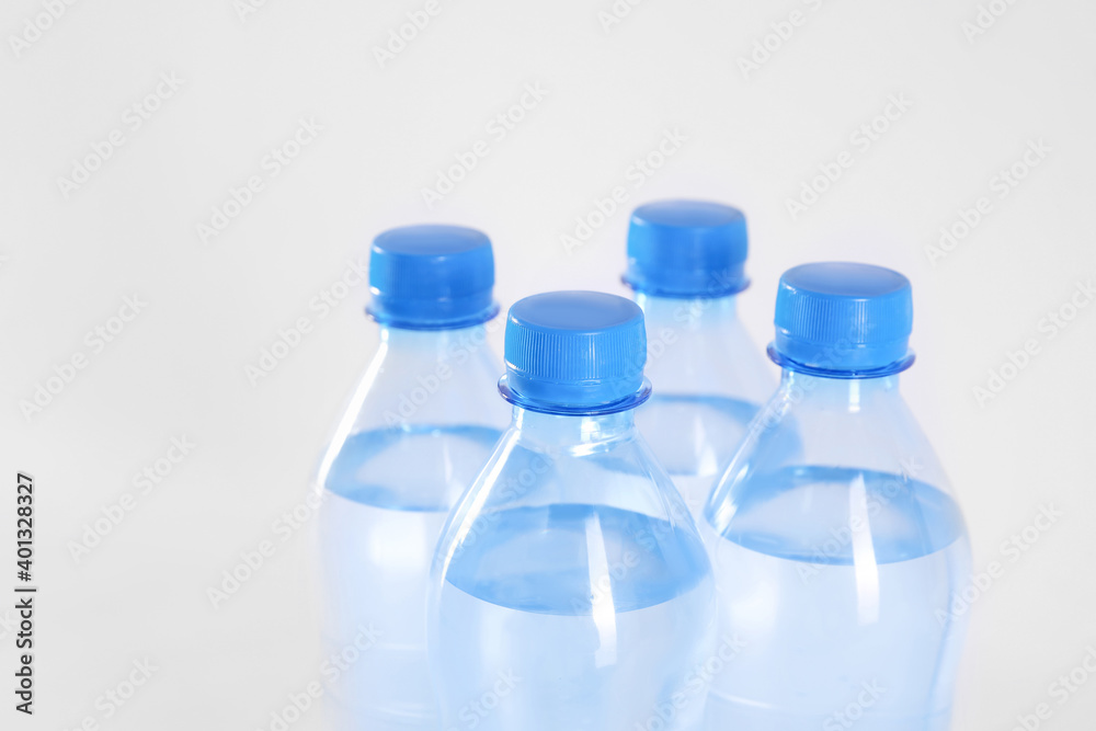 Plastic bottles with pure water on white background, closeup Plastic bottles with pure water on white background, closeup