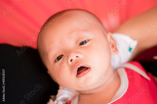 Portrait of new born baby boy resting in mothers arms,family concept,cose up.