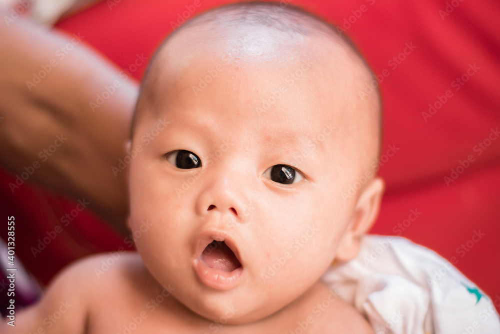 Portrait of new born baby boy resting in mothers arms,family concept,cose up.