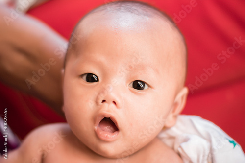 Portrait of new born baby boy resting in mothers arms,family concept,cose up.
