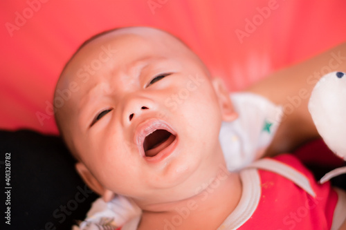 Portrait of new born baby boy resting in mothers arms,family concept,cose up.