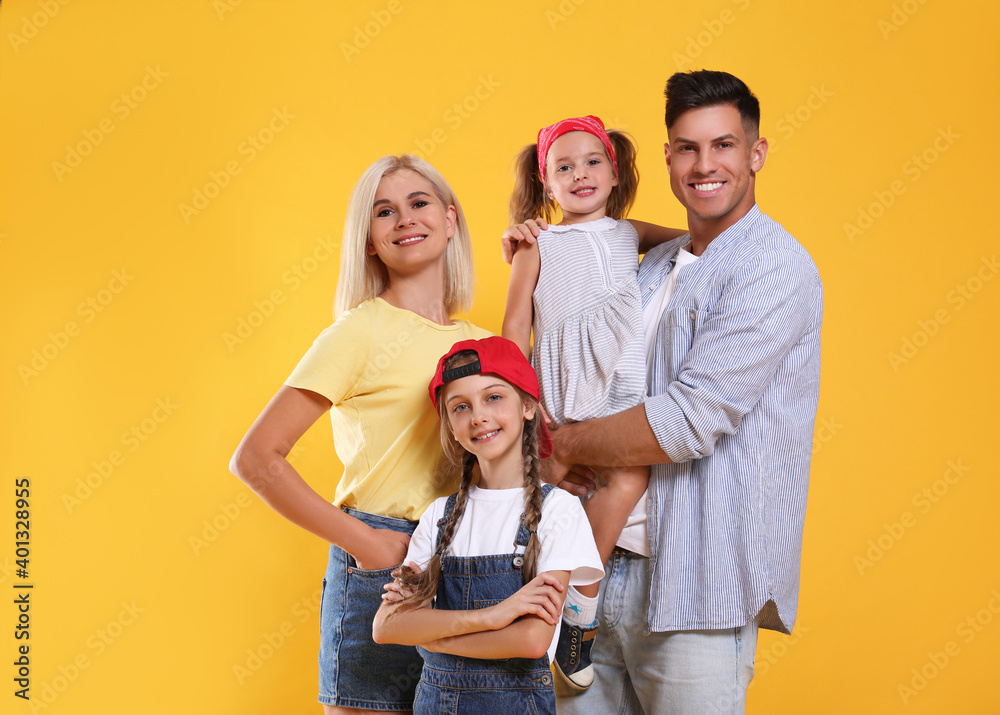 Portrait of happy family on yellow background Portrait of happy family on yellow background