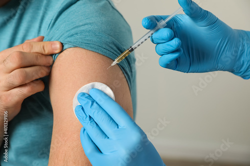 Doctor giving injection to patient in hospital  closeup. Vaccination day