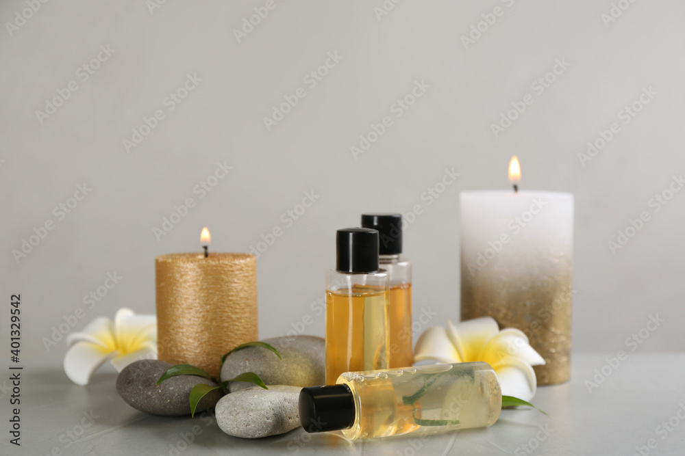 Beautiful composition with spa stones and candles on table