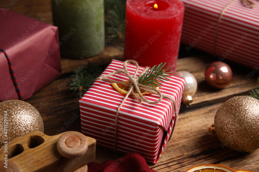 Composition with beautifully wrapped gift box on wooden table