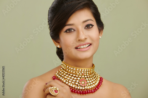 Beautiful Indian young women portrait with Indian traditional jewelry studio shot.