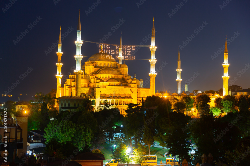 Blue Mosque at night with golden illumination, wide view of Istanbul in ...