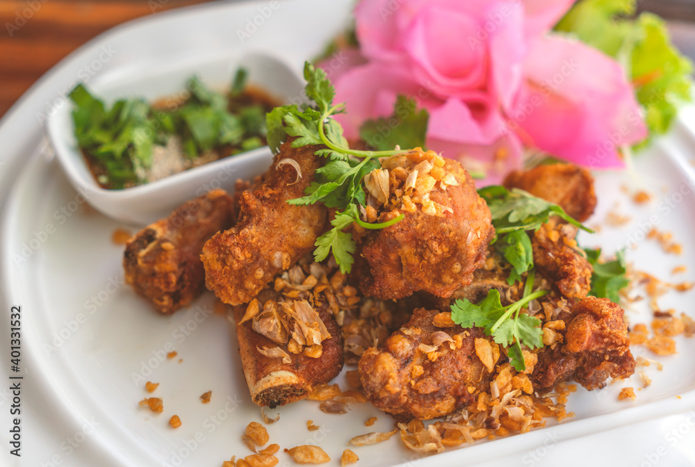Deep fried spare ribs with garlic on white plate, beautiful food decoration, close up Thailand food menu deep fried spare ribs. Deep fried spare ribs with garlic on white plate, beautiful food decoration, close up Thailand food menu deep fried spare ribs.