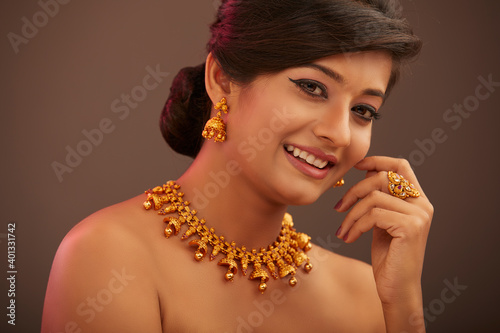 Pretty Indian young women portrait with jewelry in studio shot.