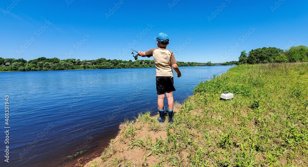 child fishing on a river