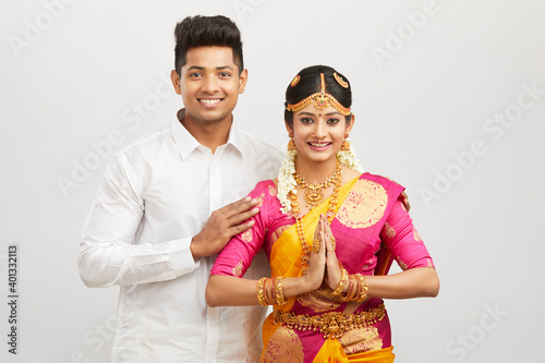 Attractive south Indian couple greeting namaste in traditional dress