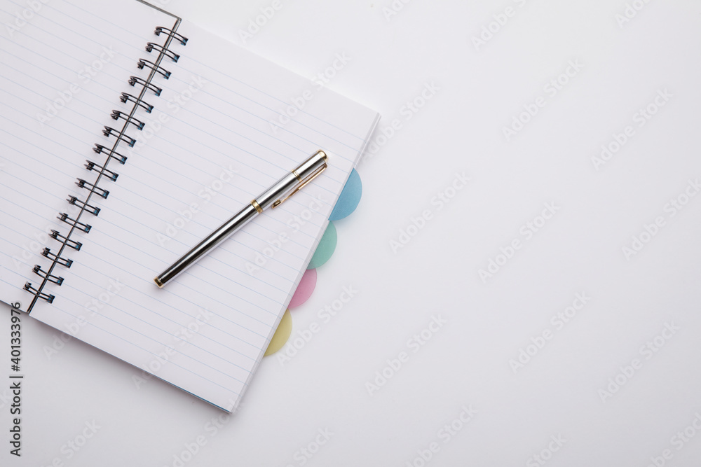 Notebook with notes and pen on white background. Notebook with notes and pen on white background.