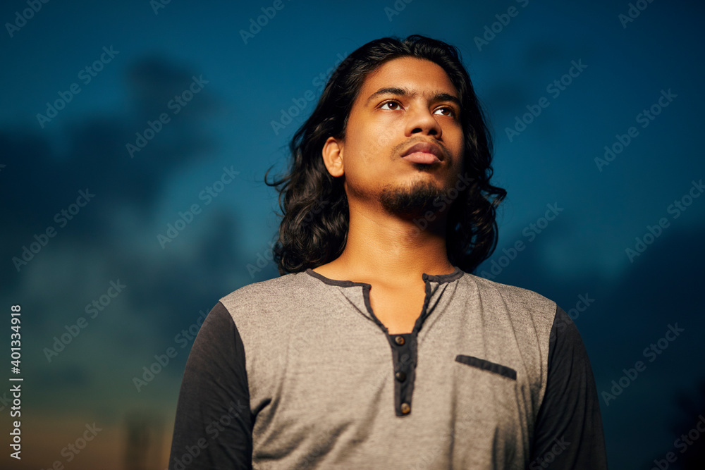 Young man portrait with long hair in evening light Young man portrait with long hair in evening light