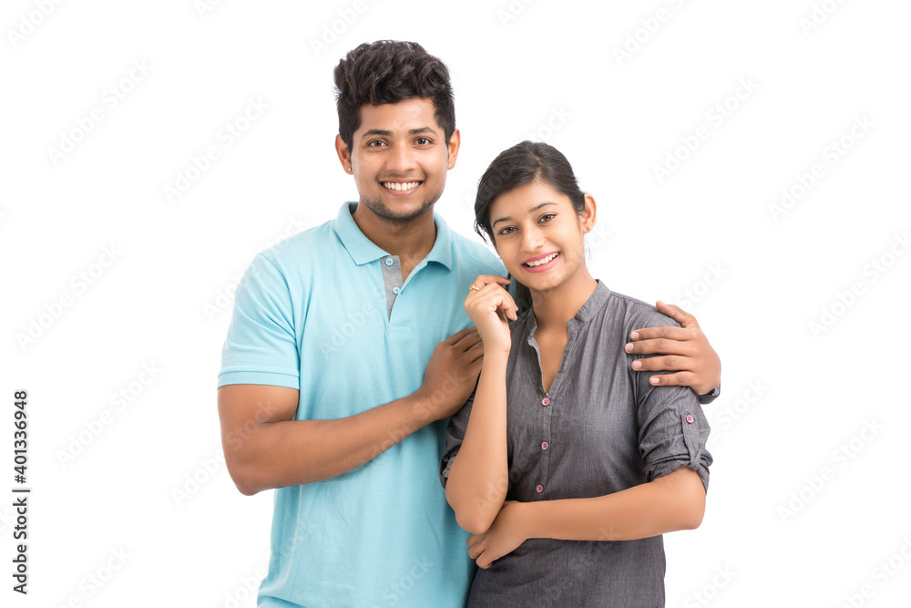 Beautiful happy young couple looking at the camera on white.