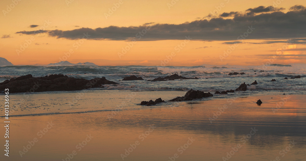 Beautiful sunset with waves in the sea and clouds in the background Beautiful sunset with waves in the sea and clouds in the background