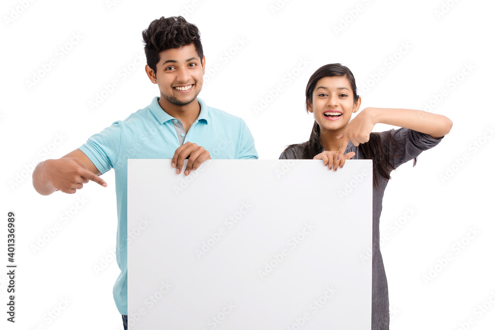 Cheerful cute young couples holding white board isolated on white. Cheerful cute young couples holding white board isolated on white.