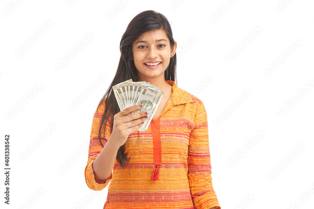 Young happy woman holding 500 rupee notes against white background Young happy woman holding 500 rupee notes against white background