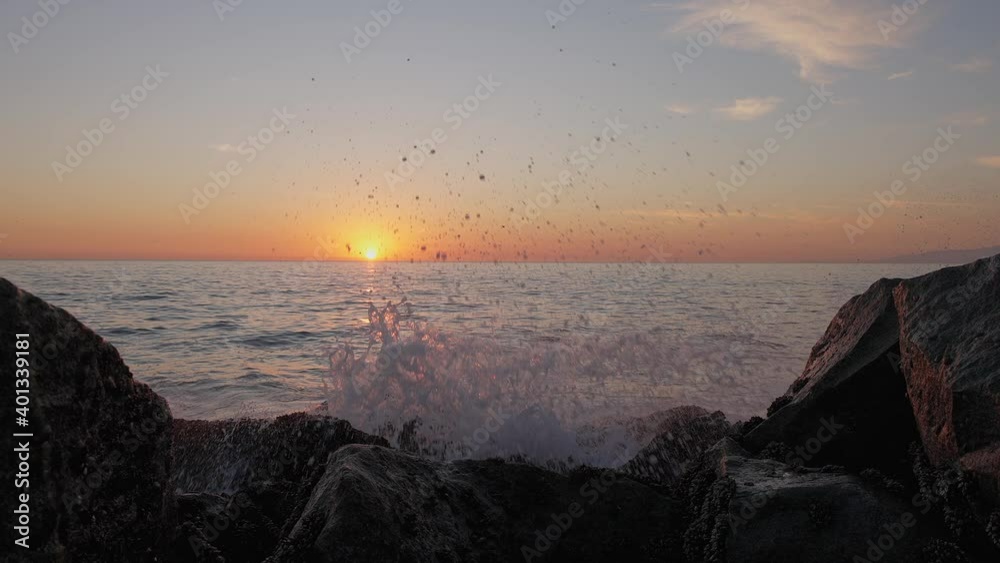 Dramatic ocean sunset. Burning sky and shining golden waves hit rocks. Sunset sea 4k. Seagulls are flying. Red sky, yellow sun and amazing sea. Summer sunset seascape. Slow motion. Dramatic ocean sunset. Burning sky and shining golden waves hit rocks. Sunset sea 4k. Seagulls are flying. Red sky, yellow sun and amazing sea. Summer sunset seascape. Slow motion.