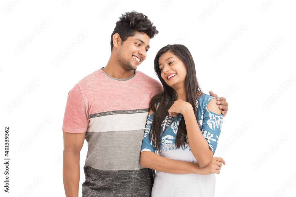 Beautiful happy young couple looking at the camera on white. Beautiful happy young couple looking at the camera on white.