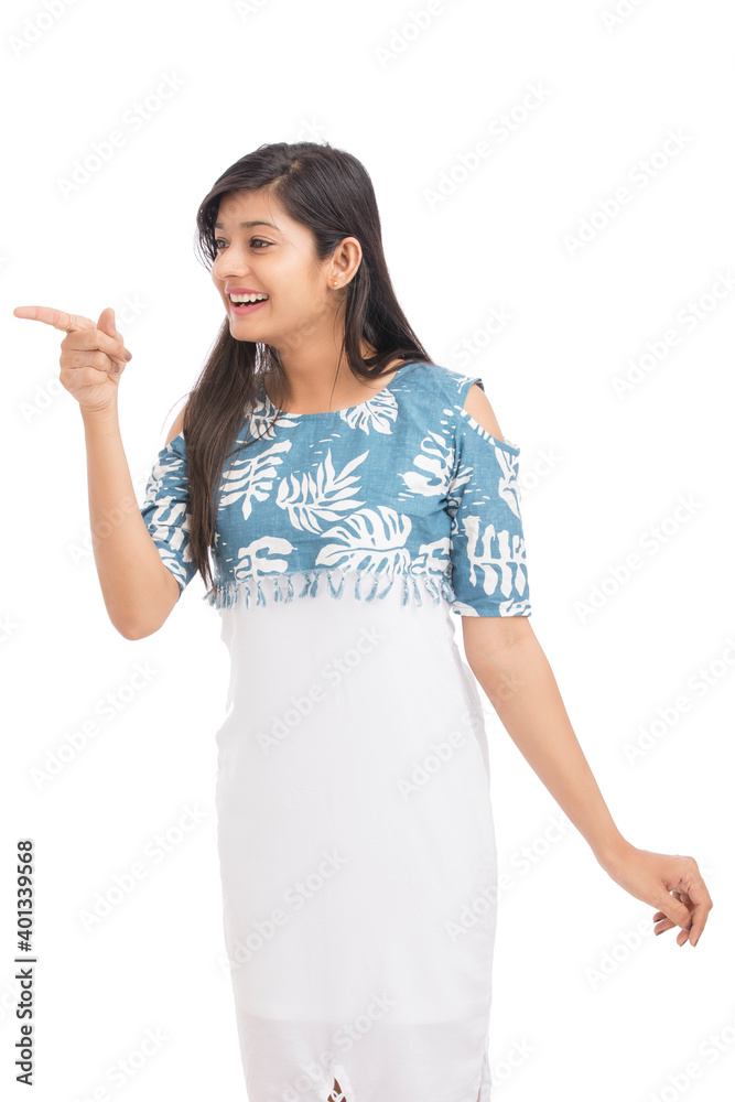 Cheerful attractive young women pointing over white. Cheerful attractive young women pointing over white.