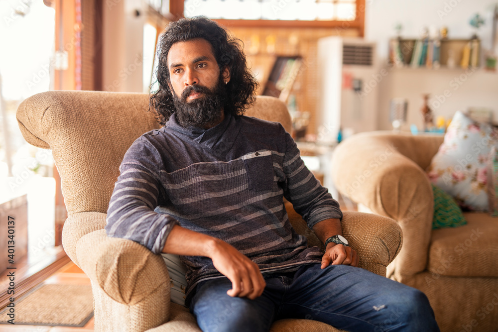 Fototapeta premium Long hair young man relaxing at home.